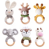 A collection of crochet bunny and elephant rattles with natural wood teether rings.