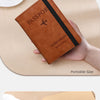 A close-up of a black RFID-blocking passport cover and travel wallet made of leather, shown in use.