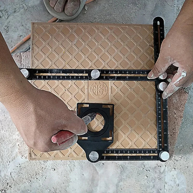 A hand is using a foldable aluminum angle ruler with locking segments on a brown board.