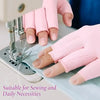 Pink fingerless compression gloves being used for sewing and daily necessities