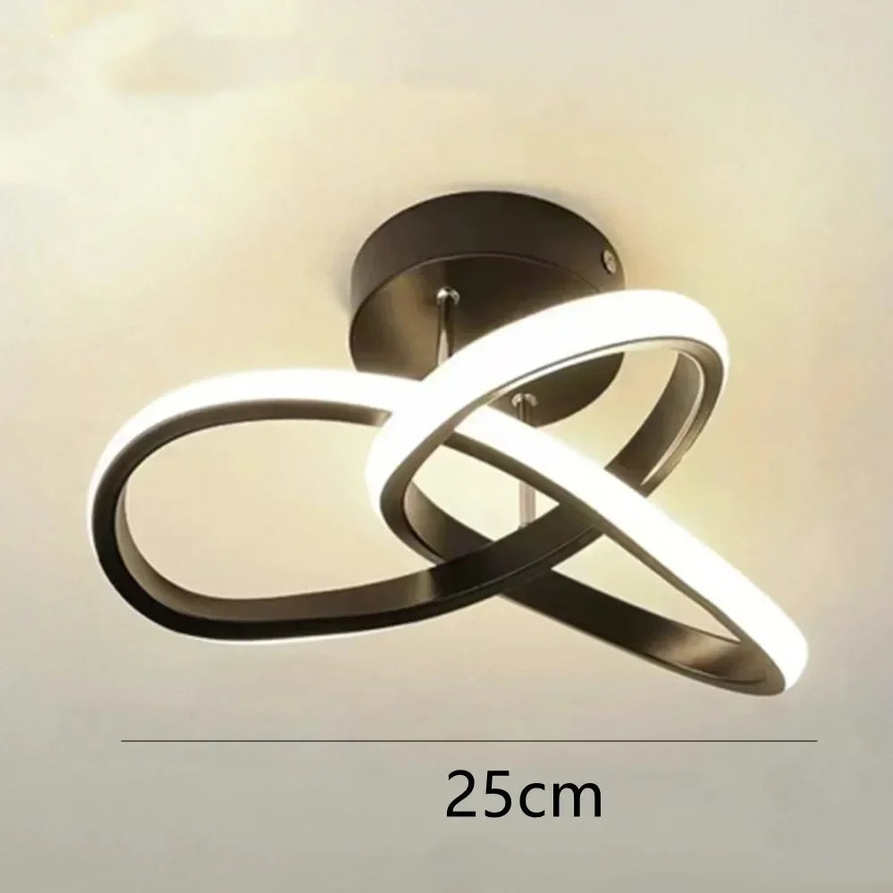 Modern clover shaped LED ceiling light fixture with a curved, glowing white design.