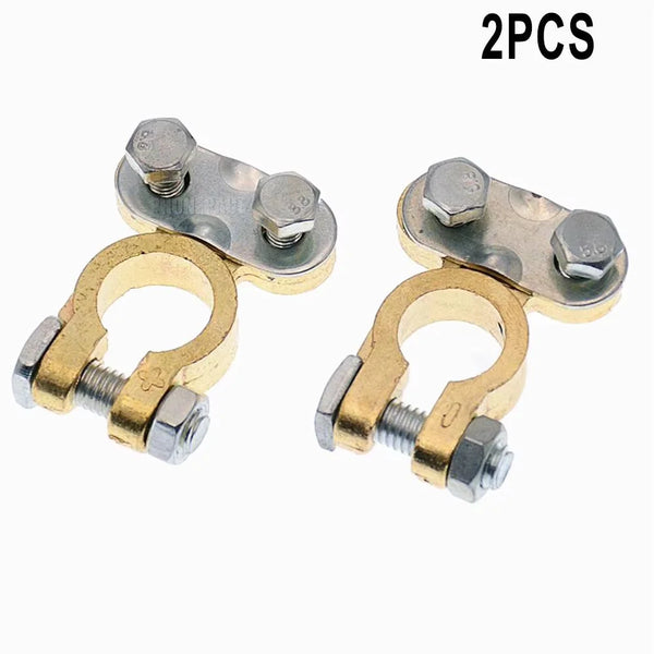 Two heavy-duty brass battery terminals with threaded clamps and rings.