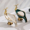 Gold and green leaf-shaped ceramic soap dish with a deer figurine and drain rack