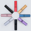 A collection of refillable aluminum perfume atomizers in various colors including black, red, gold, rose gold, blue, silver, 