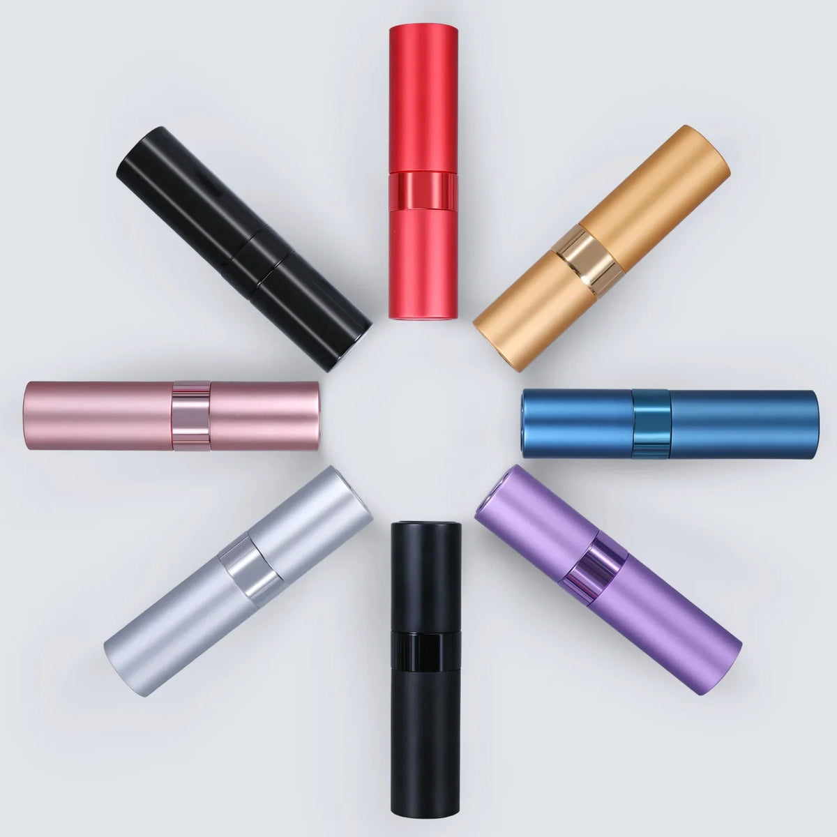 A collection of refillable aluminum perfume atomizers in various colors including black, red, gold, rose gold, blue, silver, 