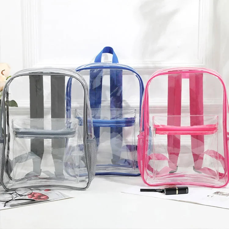 A collection of transparent PVC backpacks in blue, pink, and gray are displayed on a white surface.