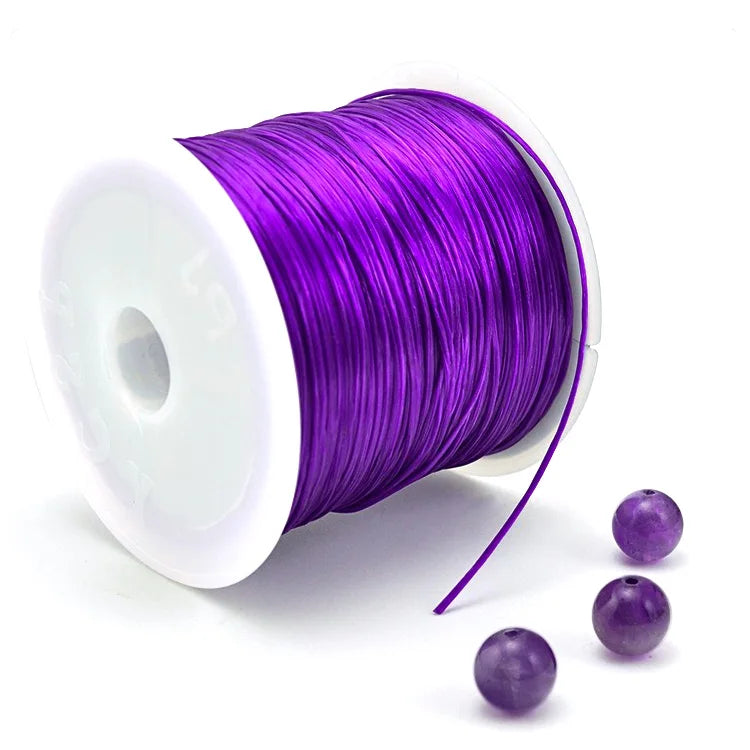 A roll of purple elastic cord for beading and jewelry making with a thin strand unwound.