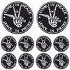 Ten black embroidered iron-on patches featuring a hand making a peace sign with a sword, surrounded by the text Come in Peace