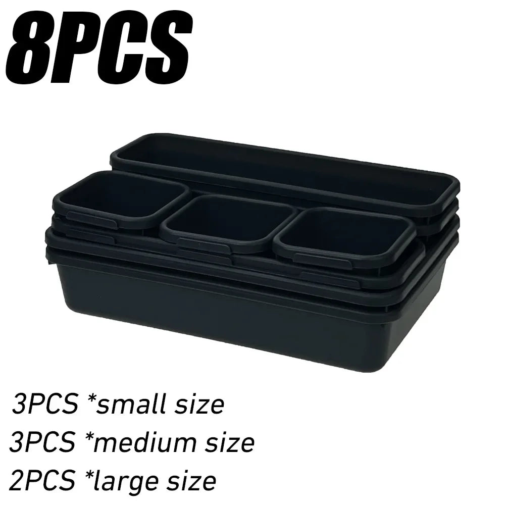 Black modular drawer organizer trays with interlocking dividers in small, medium, and large sizes.