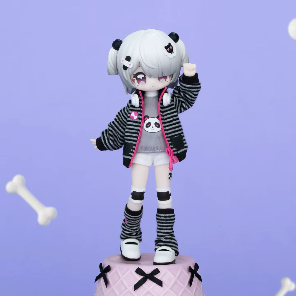 A white-haired anime-style collectible figurine with black and pink clothing standing on a pink base.