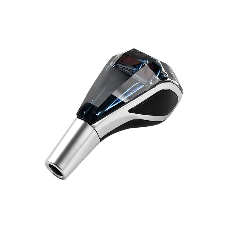 A close-up view of a universal LED illuminated crystal gear shift knob with a silver base and black finish.