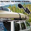 A set of heavy duty ratchet tie down straps is shown being used to secure a roof rack on a silver SUV.