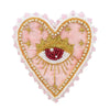 A heart-shaped patch featuring a pink fabric with a gold crown and an eye design embellished with white pearls and rhinestone