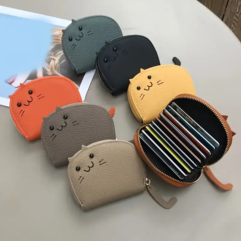 A collection of cartoon cat-shaped PU leather card wallets in various colors including gray, black, yellow, and orange.