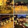 Moroccan ball string lights illuminating a dark outdoor setting with warm glowing bulbs