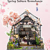 A detailed miniature Japanese sakura greenhouse tea house model featuring pink blossoms and traditional architecture.