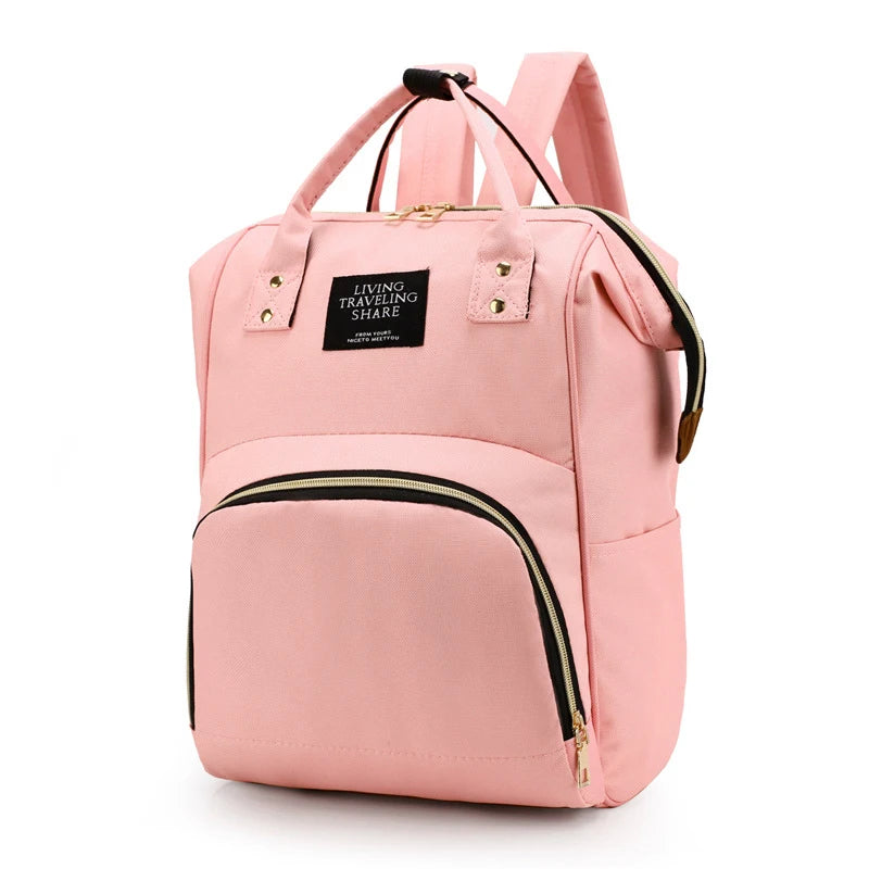 Pink insulated canvas mummy diaper bag with a hanging hook and zippered pocket