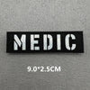 Black fabric patch with white text MEDIC and dimensions 9.0x2.5cm