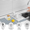 Silicone dish drying mat with drainage ramp placed under a kitchen sink