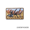 A tan embroidered patch featuring a silhouette of a deer head and mountain peaks, with the word COLORADO below it.