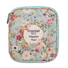 A light green crochet hook organizer bag featuring a floral pattern on the fabric.