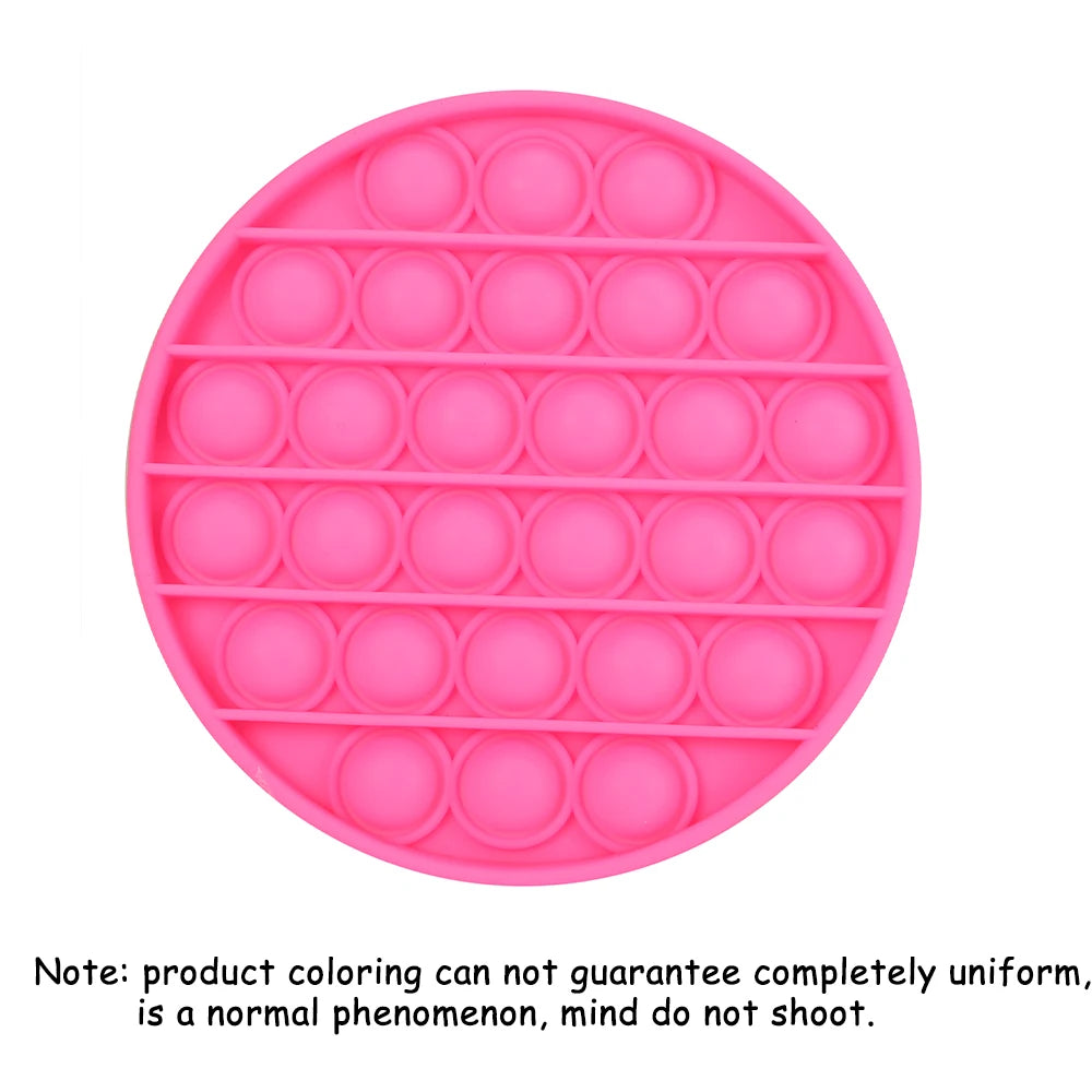 A pink Pop-It fidget board with multiple circular bubbles for sensory stress relief.