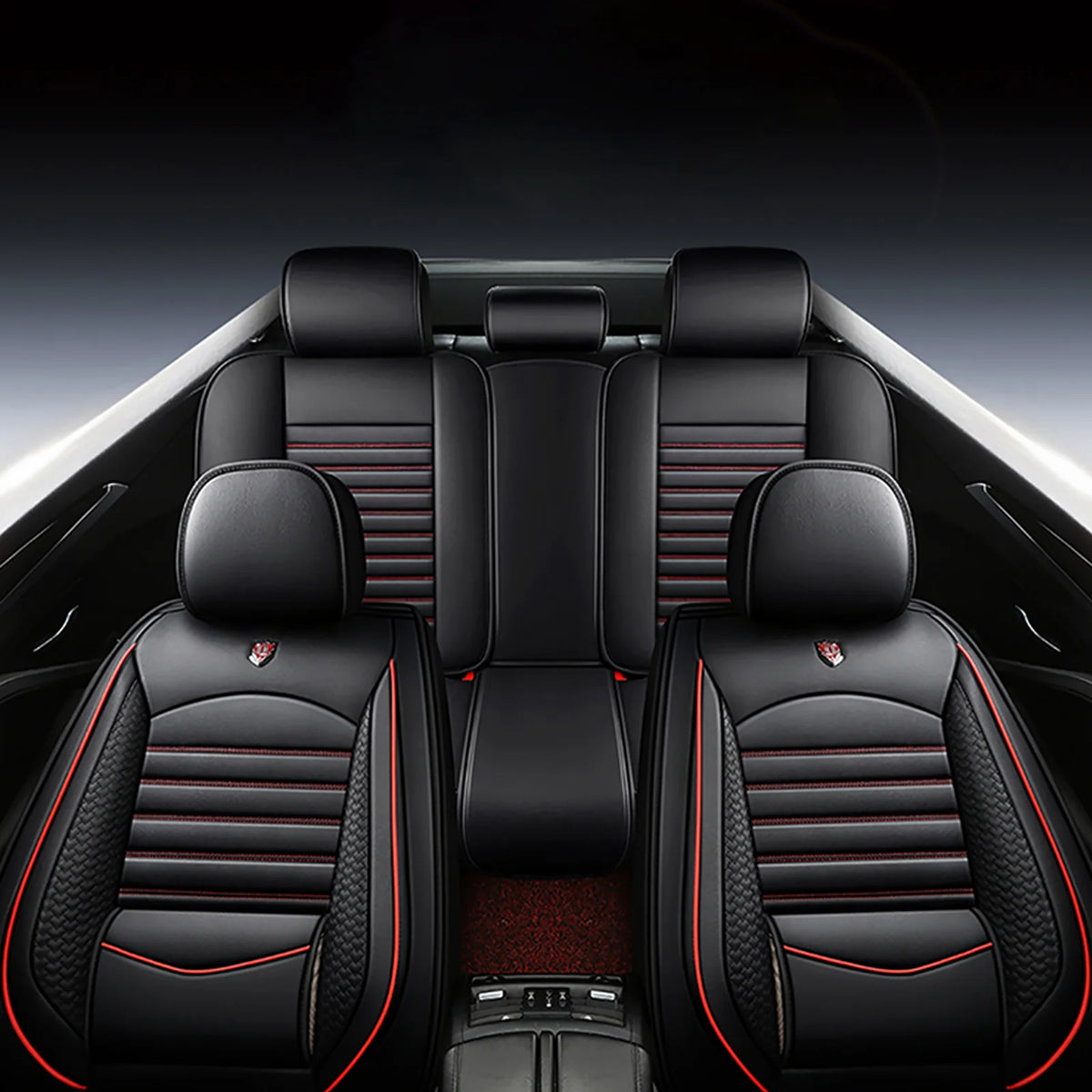 Interior view of a car with black leather seat covers featuring red stitching and accents.