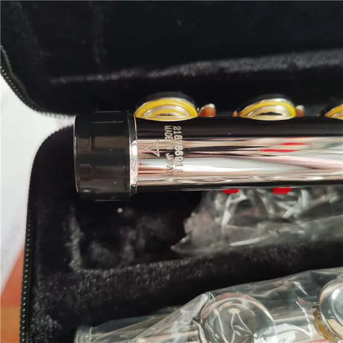 Silver-plated 16-hole flute in C key with E mechanism inside a black velvet box.