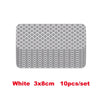 A set of ten white 3x8cm high-visibility reflective strip stickers for car safety.
