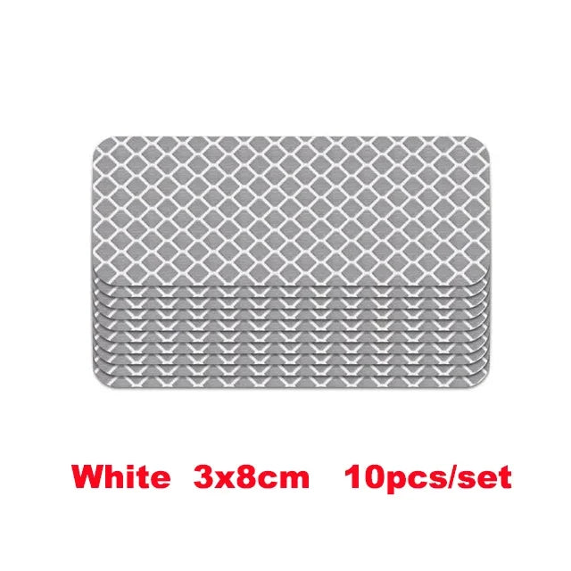 A set of ten white 3x8cm high-visibility reflective strip stickers for car safety.