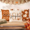 A white pumpkin pillow cover with black script text on an orange fabric background, displayed against a wooden shelf.