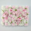 A dense wall panel of pink and white silk rose flowers for weddings and events.
