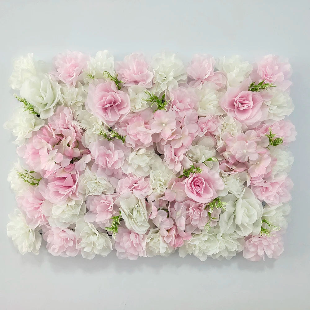 A dense wall panel of pink and white silk rose flowers for weddings and events.