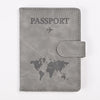 A gray leather passport holder with the word PASSPORT and a world map design.
