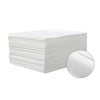 A stack of white premium disposable bed sheets for salons, spas, and travel, with a close-up view of the fabric texture.