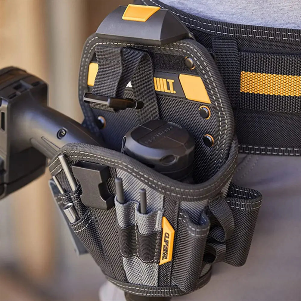 A black ClipTech heavy-duty drill holster with a yellow belt hub is shown attached to a gray fabric strap.