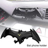 Black bat-shaped phone holder designed to fit into car vents.