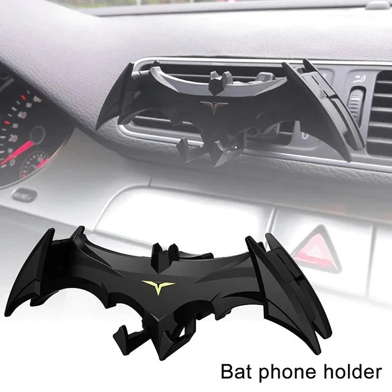 Black bat-shaped phone holder designed to fit into car vents.