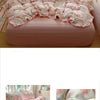 A pink floral duvet cover set with matching pillowcases and a flat sheet displayed on a bed.