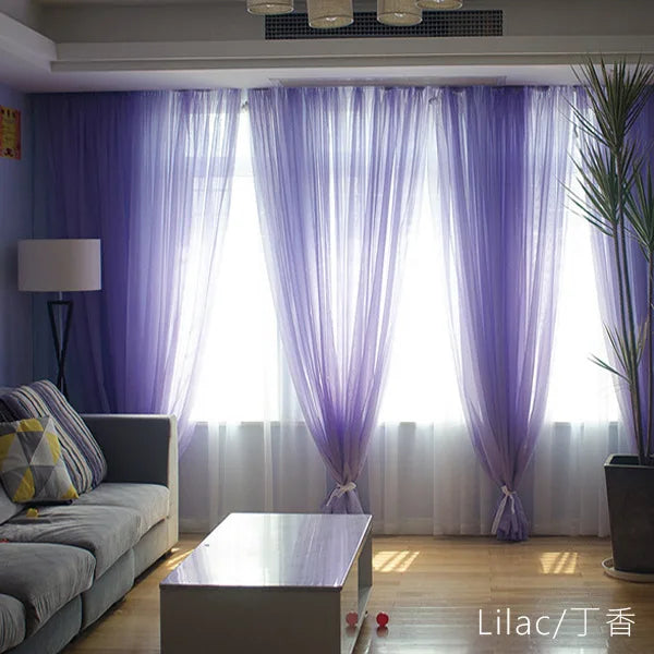 Purple sheer voile curtains hanging in a window with white sheer undercurtains and a modern interior.