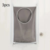 A gray wall-mounted laundry storage bag with a circular opening is displayed against a white wall.