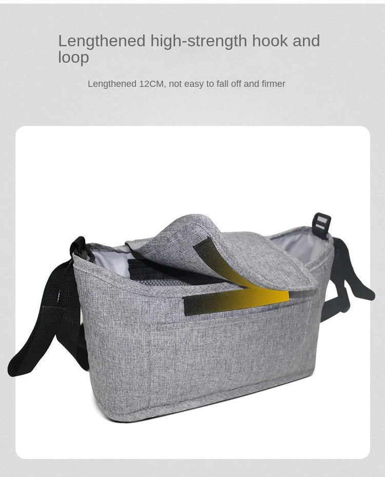Gray organizer bag for strollers featuring a lengthened hook and loop for secure attachment.