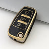 A black and gold protective TPU key fob cover for an Audi flip key, shown from above.
