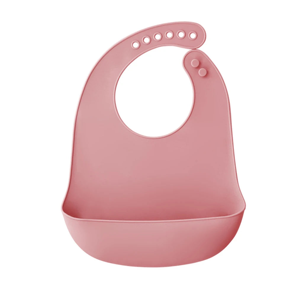 A pink ultra-thin silicone baby bib with a catch pocket for feeding