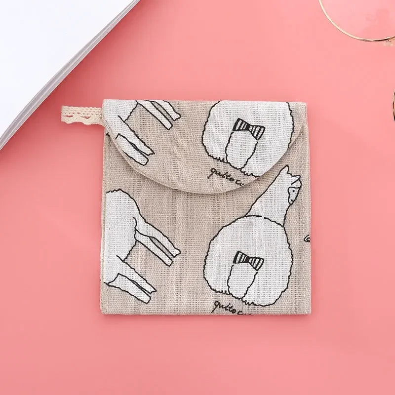 A beige cosmetic storage pouch with a light pink background featuring line drawings of sheep and a bow detail.