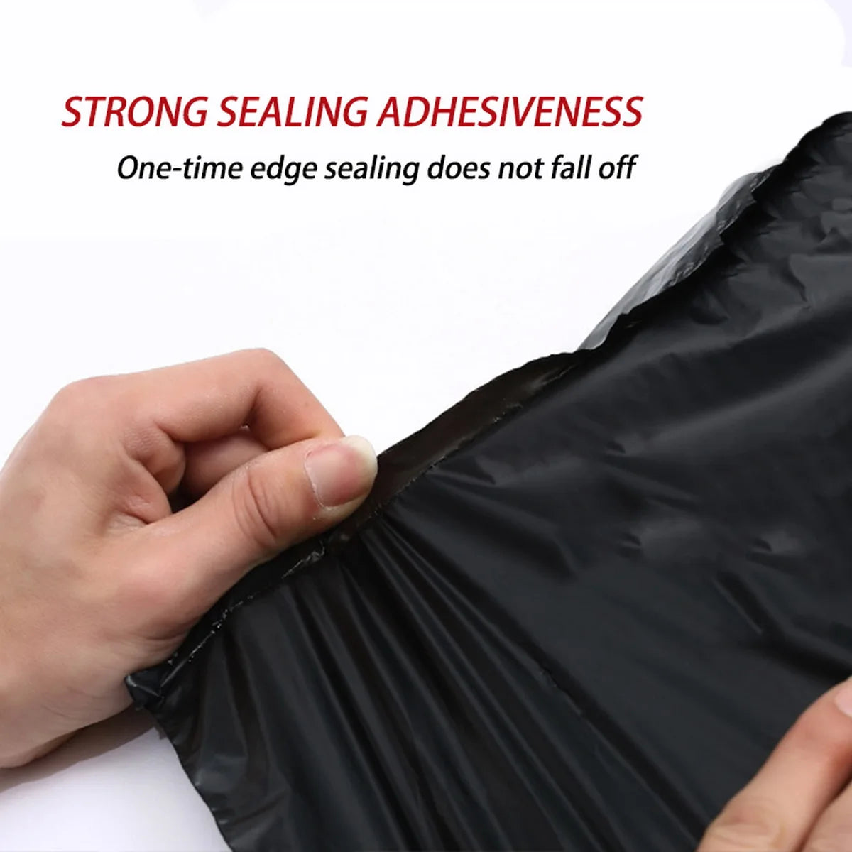 A hand is sealing a black self-seal poly mailer bag, demonstrating strong sealing adhesiveness.