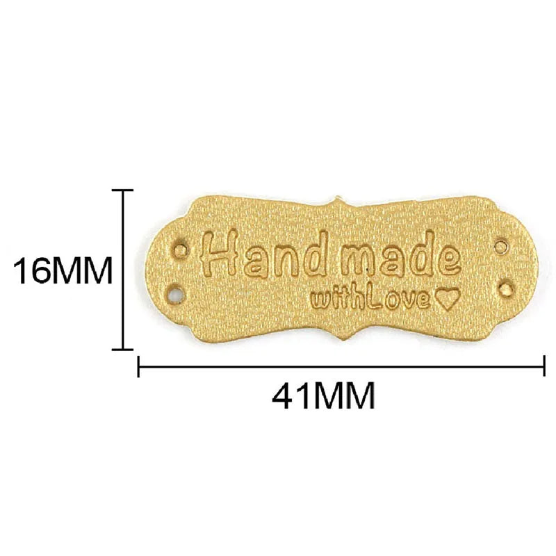 Gold-colored PU leather handmade sewing labels with a heart design, measuring 16mm by 41mm.