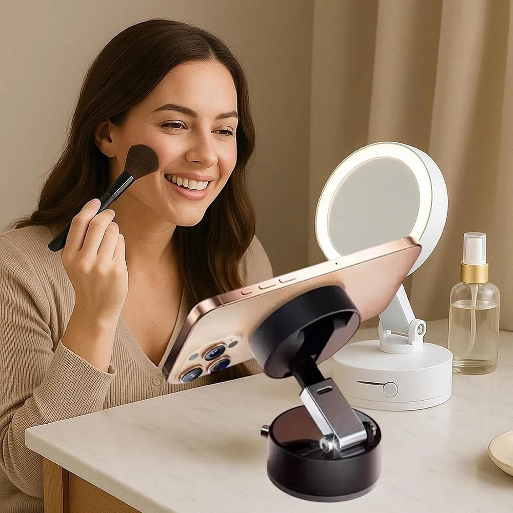 A woman is using a magnetic foldable car phone mount with dual-side adhesion on a table.
