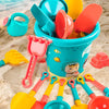 A collection of 18 plastic beach and sand toys in various colors like yellow, orange, pink, and blue resting on sand.