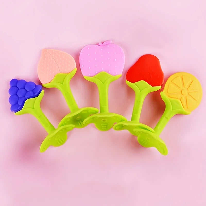 A set of silicone baby teethers shaped like strawberries in pink, red, and yellow colors.